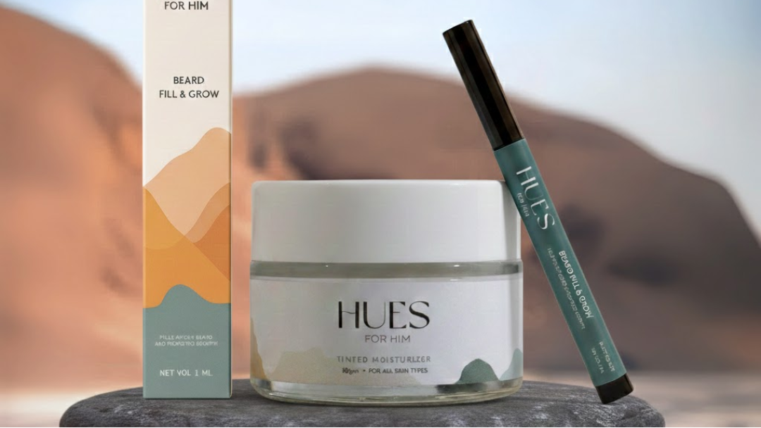 HUES skincare products including a jar, pen, and box on a blurred background